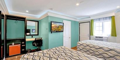 Queen room with mini-fridge at Mid City Inn - Los Angeles.