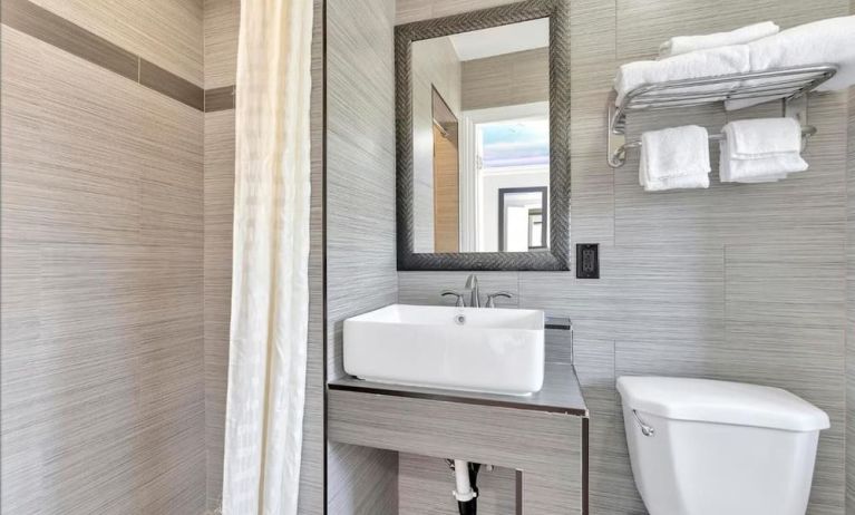 Private bathroom with shower at Mid City Inn - Los Angeles.
