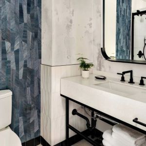 Private guest bathroom with shower and free toiletries at Kimpton Theta New York - Times Square.