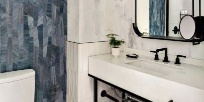 Private guest bathroom with shower and free toiletries at Kimpton Theta New York - Times Square.