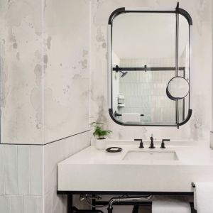 Private guest bathroom with shower and free toiletries at Kimpton Theta New York - Times Square.
