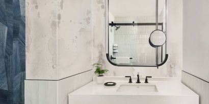 Private guest bathroom with shower and free toiletries at Kimpton Theta New York - Times Square.