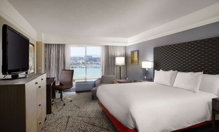 Day use room with king bed, work desk and TV screen at DoubleTree By Hilton San Francisco Airport North Bayfront.