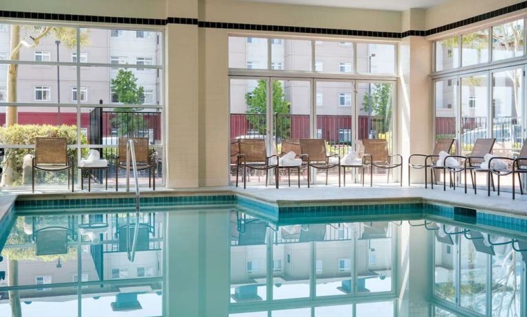 Relaxing indoor pool with lounge seating at DoubleTree By Hilton San Francisco Airport North Bayfront.