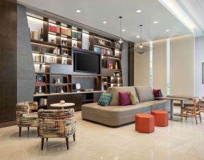 Lobby lounge area and workspace at 	Home2 Suites By Hilton Denver Downtown Convention Center.