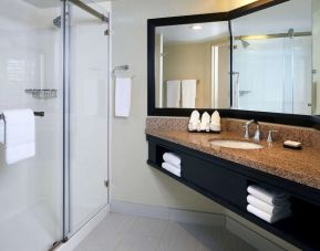 Private guest bathroom with shower and free toiletries at Embassy Suites By Hilton Los Angeles-Intl Airport North.