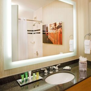Private guest bathroom with shower and free toiletries at Hilton Newark Airport.