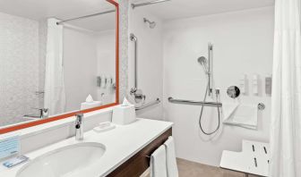 Private guest bathroom with shower and free toiletries at Hampton Inn Chicago/Naperville.