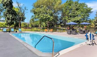 Outdoor pool with lounge chairs at Hampton Inn Chicago/Naperville.