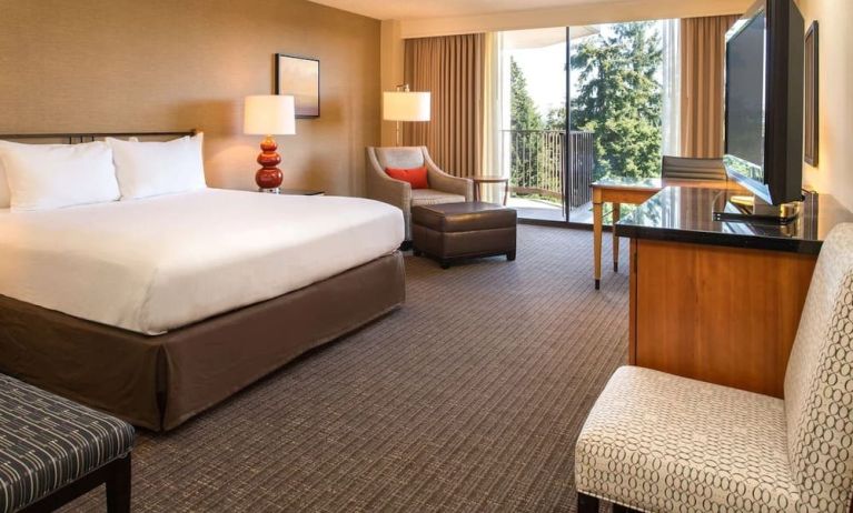 Comfortable king bedroom with balcony at the DoubleTree by Hilton Seattle Airport.