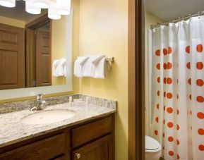 Private guest bathroom with shower and free toiletries at Sonesta Simply Suites Phoenix Scottsdale.