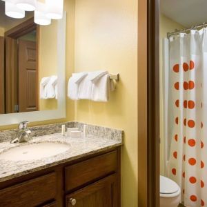 Private guest bathroom with shower and free toiletries at Sonesta Simply Suites Phoenix Scottsdale.