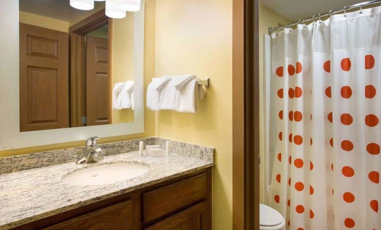 Private guest bathroom with shower and free toiletries at Sonesta Simply Suites Phoenix Scottsdale.