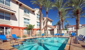 Outdoor pool with lounge chairs at Sonesta Simply Suites Phoenix Scottsdale.