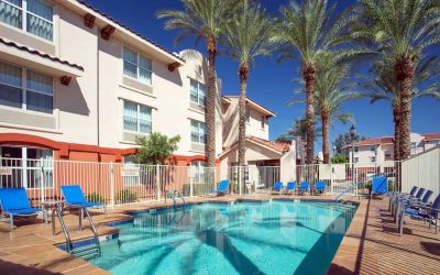 Outdoor pool with lounge chairs at Sonesta Simply Suites Phoenix Scottsdale.