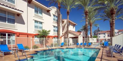 Outdoor pool with lounge chairs at Sonesta Simply Suites Phoenix Scottsdale.