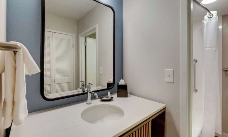 Private guest bathroom with shower and free toiletries at Sonesta Select Scottsdale At Mayo Clinic Campus.