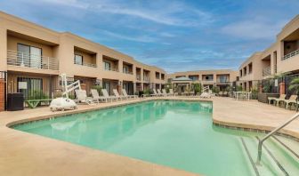Outdoor pool with lounge chairs at Sonesta Select Scottsdale At Mayo Clinic Campus.