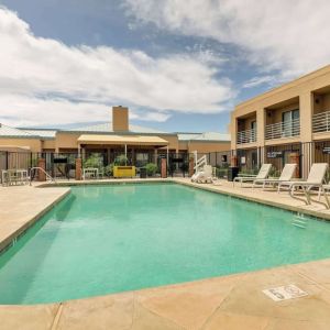 Relaxing outdoor pool with lounge chairs at Sonesta Select Scottsdale At Mayo Clinic Campus.