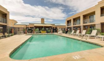 Relaxing outdoor pool with lounge chairs at Sonesta Select Scottsdale At Mayo Clinic Campus.