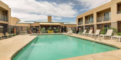 Relaxing outdoor pool with lounge chairs at Sonesta Select Scottsdale At Mayo Clinic Campus.