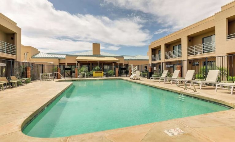 Relaxing outdoor pool with lounge chairs at Sonesta Select Scottsdale At Mayo Clinic Campus.