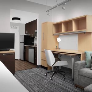 Day room amenities include TV, work desk, sofa, and in-room kitchen at TownePlace Suites Franklin Cool Springs.