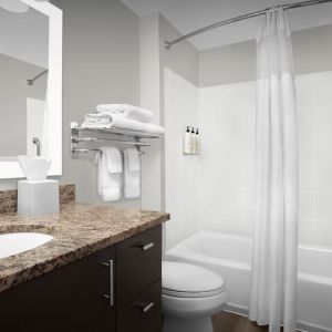 Guest bathroom with shower and tub at TownePlace Suites Franklin Cool Springs.