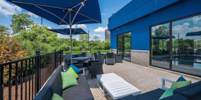 Terrace with ample seats perfect for coworking at Hampton Inn Detroit Southfield.
