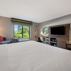 Day use room with work desk and sofa at Hampton Inn Detroit Southfield.
