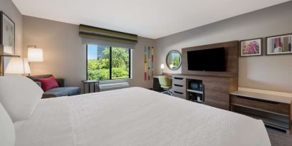 Day use room with work desk and sofa at Hampton Inn Detroit Southfield.
