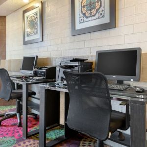 Business center with computers, printer and ergonomic chairs at Holiday Inn Express Chicago - Downers Grove.