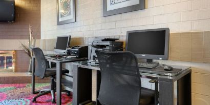 Business center with computers, printer and ergonomic chairs at Holiday Inn Express Chicago - Downers Grove.