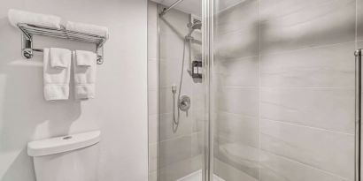 Private guest bathroom with shower at Radisson Hotel Schaumburg.