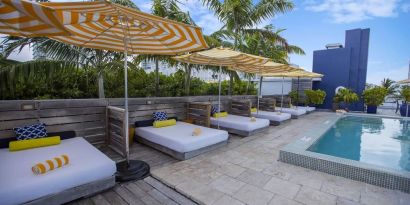 Outdoor pool with lounge beds at Catalina Hotel & Beach Club.