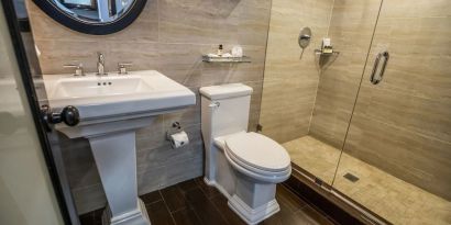 Private guest bathroom with shower and free toiletries at Hotel Croydon.