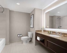 Private guest bathroom with combined tub and shower at Hilton Indianapolis Hotel & Suites.