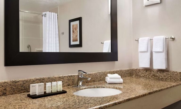 Private guest bathroom with shower and free toiletries at Embassy Suites By Hilton Convention Center Las Vegas.