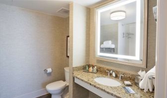 Private guest bathroom with shower and free toiletries at Hilton Baton Rouge Capitol Center.