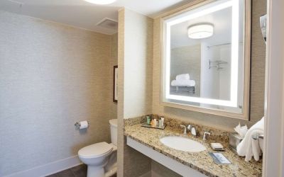 Private guest bathroom with shower and free toiletries at Hilton Baton Rouge Capitol Center.