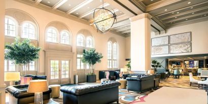 Hotel lobby with comfortable seating and workspace, perfect for coworking at Hilton Baton Rouge Capitol Center.