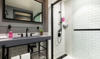 Private guest bathroom with shower at Moxy Boston Downtown.