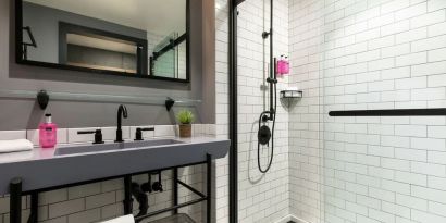 Private guest bathroom with shower at Moxy Boston Downtown.