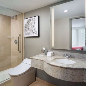 Private guest bathroom with shower at Hilton Garden Inn New York/West 35th Street.
