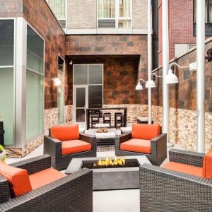 Cozy coworking space with fire pit at Hilton Garden Inn New York/West 35th Street.
