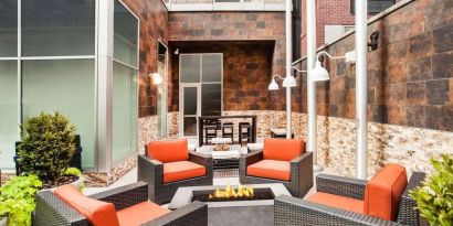 Cozy coworking space with fire pit at Hilton Garden Inn New York/West 35th Street.
