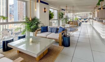 Rooftop bar and dining area with natural light at Hilton New York Fashion District.
