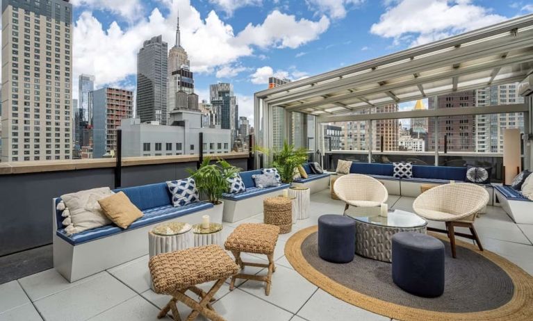 Rooftop coworking space with a view of the city at Hilton New York Fashion District.