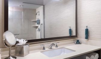 Guest bathroom with shower at Hilton New York Fashion District.