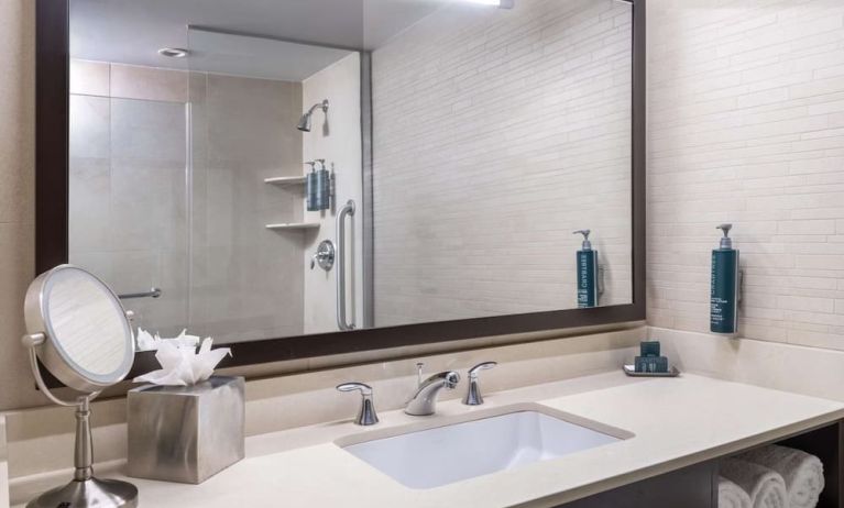 Guest bathroom with shower at Hilton New York Fashion District.